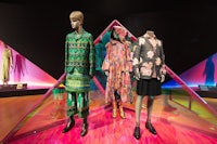 mannequins in a colorful display with a triangle in the middle
