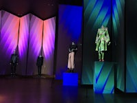 mannequins on display in a room with colorful lights